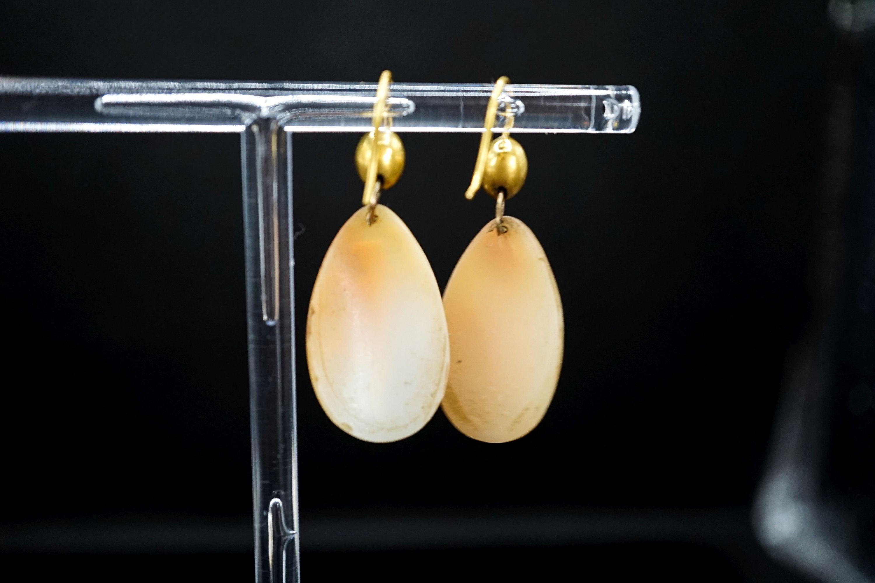 A pair of Victorian yellow metal and cameo shell ovoid earrings, carved with Mercury & Flora, shell 26mm.